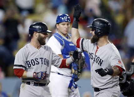 Boston Red Sox's Mike Napoli (R) celebrates after hitting a two-run home run to drive in Dustin Pedroia (L) as Los Angeles Dodgers' catcher Boston Red Sox's Mike Napoli (R) celebrates after hitting a two-run home run to drive in Dustin Pedroia (L) as Los Angeles Dodgers' catcher