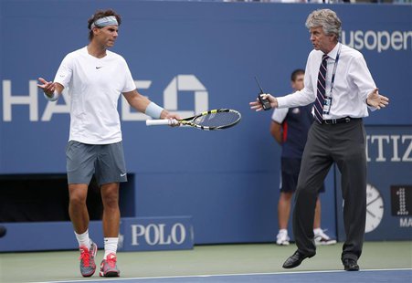 Tournament referee Brian Earley (R) and Rafael Nadal of Spain discuss resumption of play against Ryan Harrison of the U.S. despite light rai Tournament referee Brian Earley (R) and Rafael Nadal of Spain discuss resumption of play against Ryan Harrison of the U.S. despite light rai