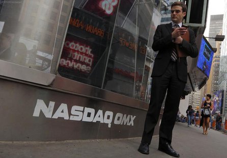 A man stands next to the Nasdaq MarketSite in New York, August 23, 2013. REUTERS/Brendan McDermid A man stands next to the Nasdaq MarketSite in New York, August 23, 2013. REUTERS/Brendan McDermid