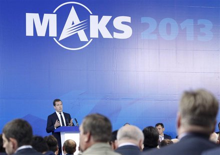 Russia's Prime Minister Dmitry Medvedev (L, back) addresses participants during a meeting opening the MAKS International Aviation and Space Russia's Prime Minister Dmitry Medvedev (L, back) addresses participants during a meeting opening the MAKS International Aviation and Space