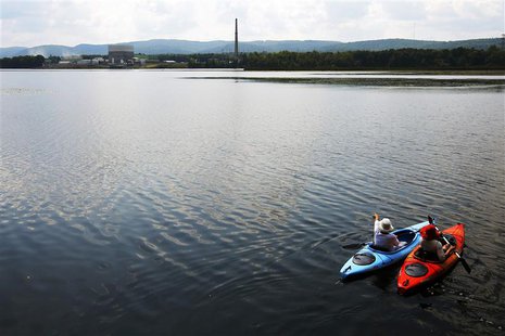 Kayakers paddle in the Connecticut River from Hinsdale, New Hampshire, in front of the Vermont Yankee nuclear power plant in Vernon, Vermont Kayakers paddle in the Connecticut River from Hinsdale, New Hampshire, in front of the Vermont Yankee nuclear power plant in Vernon, Vermont