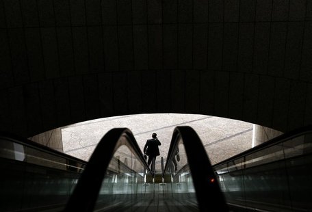 An office worker uses his mobile phone as he leaves an office building in central Sydney July 30, 2013. REUTERS/Daniel Munoz An office worker uses his mobile phone as he leaves an office building in central Sydney July 30, 2013. REUTERS/Daniel Munoz