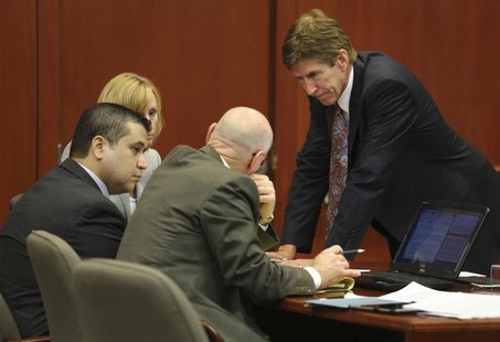 George Zimmerman confers with his defense counsel, Mark O'Mara (R), Don West (2nd R), and Lorna Truett (background) after working out the wo George Zimmerman confers with his defense counsel, Mark O'Mara (R), Don West (2nd R), and Lorna Truett (background) after working out the wo