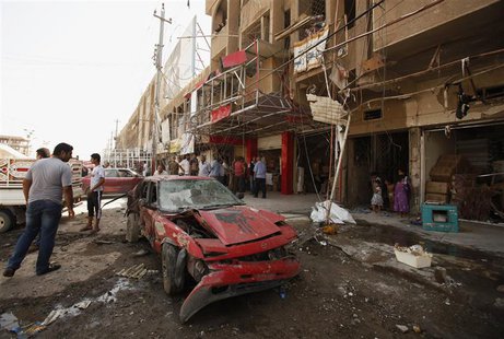 A man looks at a damaged vehicle after a car bomb attack in Baghdad's al-Shaab district August 28, 2013. REUTERS/Saad Shalash A man looks at a damaged vehicle after a car bomb attack in Baghdad's al-Shaab district August 28, 2013. REUTERS/Saad Shalash