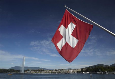 A Swiss flag is pictured next to the Jet d'Eau (water fountain), and the Lake Leman from the St-Pierre Cathedrale in Geneva June 5, 2012. RE A Swiss flag is pictured next to the Jet d'Eau (water fountain), and the Lake Leman from the St-Pierre Cathedrale in Geneva June 5, 2012. RE