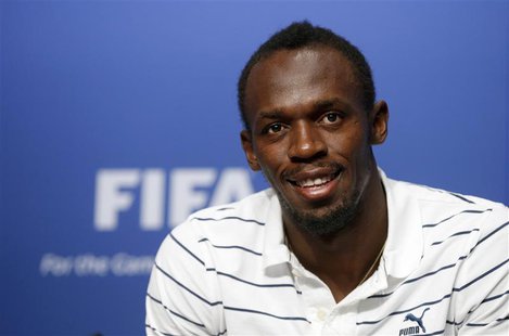 Jamaican sprinter Usain Bolt poses after a news conference during his visit to the FIFA headquarters in Zurich August 28, 2013. REUTERS/Arnd Jamaican sprinter Usain Bolt poses after a news conference during his visit to the FIFA headquarters in Zurich August 28, 2013. REUTERS/Arnd