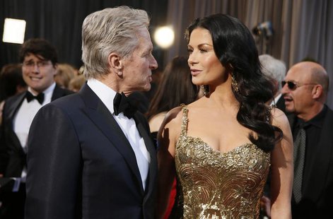 Actor Michael Douglas talks with his wife, actress Catherine Zeta-Jones, at the 85th Academy Awards in Hollywood, California February 24, 20 Actor Michael Douglas talks with his wife, actress Catherine Zeta-Jones, at the 85th Academy Awards in Hollywood, California February 24, 20