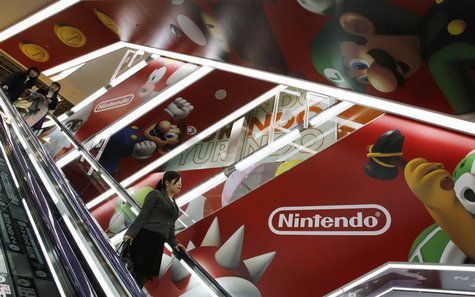 People ride an escalator past Nintendo Co advertisements at an electronics retail store in Tokyo April 23, 2013. REUTERS/Toru Hanai People ride an escalator past Nintendo Co advertisements at an electronics retail store in Tokyo April 23, 2013. REUTERS/Toru Hanai