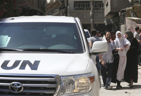 A woman (2nd R) affected by what activists said was an apparent gas attack is lead to a team of U.N. chemical weapons experts for checking d A woman (2nd R) affected by what activists said was an apparent gas attack is lead to a team of U.N. chemical weapons experts for checking d