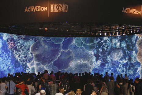 Visitors look at a presentation at the ActiVision Blizzard exhibition stand during the Gamescom 2013 fair in Cologne August 21, 2013. REUTER Visitors look at a presentation at the ActiVision Blizzard exhibition stand during the Gamescom 2013 fair in Cologne August 21, 2013. REUTER