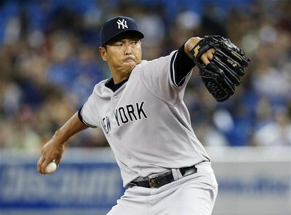 New York Yankees pitcher Hiroki Kuroda pitches against the Toronto Blue Jays during the first inning of their MLB American League baseball g New York Yankees pitcher Hiroki Kuroda pitches against the Toronto Blue Jays during the first inning of their MLB American League baseball g