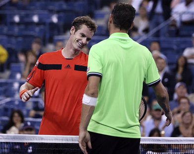 Andy Murray of Britain shakes hands at the net with Michael Llodra of France after winning his opening match at the U.S. Open tennis champio Andy Murray of Britain shakes hands at the net with Michael Llodra of France after winning his opening match at the U.S. Open tennis champio