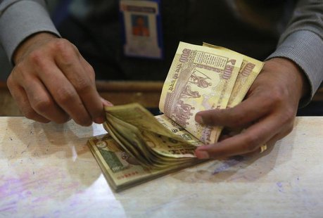 A cashier counts Indian rupee currency notes inside a bank in Mumbai August 5, 2013. REUTERS/Danish Siddiqui A cashier counts Indian rupee currency notes inside a bank in Mumbai August 5, 2013. REUTERS/Danish Siddiqui