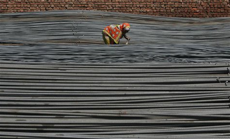 A labourer works inside an iron factory on the outskirts of Jammu October 1, 2012. REUTERS/Mukesh Gupta A labourer works inside an iron factory on the outskirts of Jammu October 1, 2012. REUTERS/Mukesh Gupta