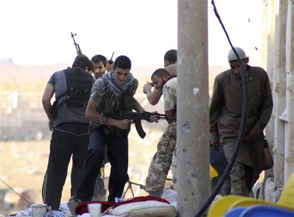 Free Syrian Army fighters take cover during what they said were clashes with forces loyal to Syria's President Bashar Al-Assad in Al Rashedd Free Syrian Army fighters take cover during what they said were clashes with forces loyal to Syria's President Bashar Al-Assad in Al Rashedd