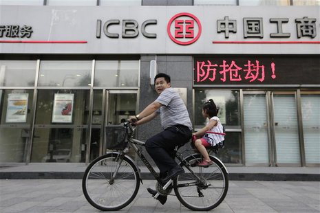 A man and his daughter ride a bicycle past a branch of the Industrial and Commercial Bank of China Ltd (ICBC) in Beijing June 26, 2013. REUT A man and his daughter ride a bicycle past a branch of the Industrial and Commercial Bank of China Ltd (ICBC) in Beijing June 26, 2013. REUT