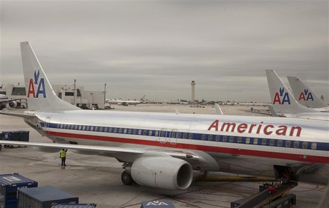A worker walks underneath an American Airlines airplane at Miami International airport in Miami, Florida November 29, 2011. REUTERS/Lucas Ja A worker walks underneath an American Airlines airplane at Miami International airport in Miami, Florida November 29, 2011. REUTERS/Lucas Ja