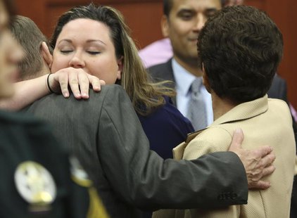 George Zimmerman's wife, Shellie (2nd L), hugs her Father-in-law Robert Zimmerman Sr. (L) and after her husband was found not guilty in the George Zimmerman's wife, Shellie (2nd L), hugs her Father-in-law Robert Zimmerman Sr. (L) and after her husband was found not guilty in the