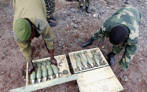 Congolese army fighters arrange their ammunitions as they take position to guard against the M23 rebels in Kibati village, near Goma in the Congolese army fighters arrange their ammunitions as they take position to guard against the M23 rebels in Kibati village, near Goma in the