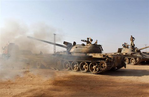 Free Syrian Army fighters drive a military tank that belonged to forces loyal to Syria's President Bashar Al-Assad after they seized it, in Free Syrian Army fighters drive a military tank that belonged to forces loyal to Syria's President Bashar Al-Assad after they seized it, in