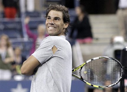 Rafael Nadal of Spain hits tennis balls into the crowd after defeating Rogerio Dutra Silva of Brazil at the U.S. Open tennis championships i Rafael Nadal of Spain hits tennis balls into the crowd after defeating Rogerio Dutra Silva of Brazil at the U.S. Open tennis championships i