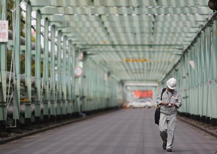 A man walks inside a factory at Keihin industrial zone in Kawasaki, south of Tokyo June 28, 2013. REUTERS/Yuya Shino A man walks inside a factory at Keihin industrial zone in Kawasaki, south of Tokyo June 28, 2013. REUTERS/Yuya Shino