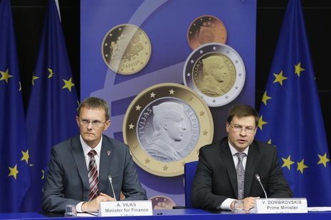 Latvia's Prime Minister Valdis Dombrovskis and Finance Minister Andris Vilks (L) address a news conference on the adoption of the euro by La Latvia's Prime Minister Valdis Dombrovskis and Finance Minister Andris Vilks (L) address a news conference on the adoption of the euro by La