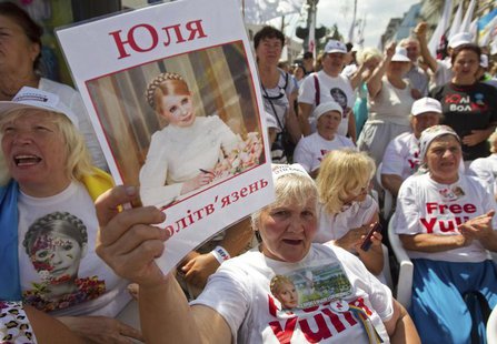 A supporter of jailed former Ukrainian Prime Minister and opposition leader Yulia Tymoshenko holds a portrait of her during a rally in centr A supporter of jailed former Ukrainian Prime Minister and opposition leader Yulia Tymoshenko holds a portrait of her during a rally in centr