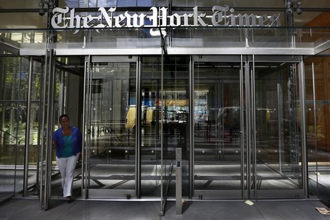 A woman exits the New York Times Building in New York August 14, 2013. REUTERS/Brendan McDermid A woman exits the New York Times Building in New York August 14, 2013. REUTERS/Brendan McDermid