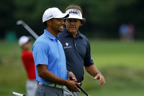 Tiger Woods (L) and Phil Mickelson, both of the United States, walk up the sixth fairway during the first round of the Deutsche Bank Champio Tiger Woods (L) and Phil Mickelson, both of the United States, walk up the sixth fairway during the first round of the Deutsche Bank Champio