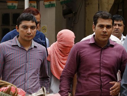Plainclothes policemen escort an Indian teenager (head covered with towel) after he was sentenced at a juvenile court in New Delhi August 31 Plainclothes policemen escort an Indian teenager (head covered with towel) after he was sentenced at a juvenile court in New Delhi August 31