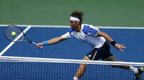 David Ferrer of Spain lunges to make a shot at the net against Mikhail Kukushkin of Kazakhstan at the U.S. Open tennis championships in New David Ferrer of Spain lunges to make a shot at the net against Mikhail Kukushkin of Kazakhstan at the U.S. Open tennis championships in New