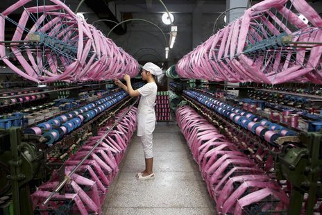 An employee works inside a silk factory in Neijiang, Sichuan province, July 3, 2013. REUTERS/China Daily An employee works inside a silk factory in Neijiang, Sichuan province, July 3, 2013. REUTERS/China Daily