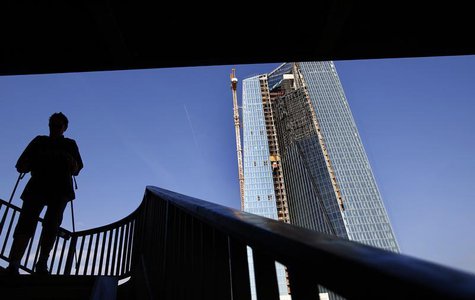A woman with walking sticks is silhouetted against the sky as she descends steps from a bridge next to the construction site for the new hea A woman with walking sticks is silhouetted against the sky as she descends steps from a bridge next to the construction site for the new hea