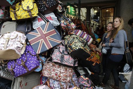 Shoppers browse handbags for sale at Covent Garden market in central London August 6, 2013. REUTERS/Chris Helgren Shoppers browse handbags for sale at Covent Garden market in central London August 6, 2013. REUTERS/Chris Helgren