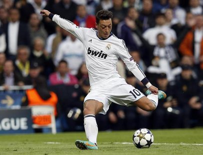 Real Madrid's Mesut Ozil shoots towards the goal of Borussia Dortmund during their Champions League semi-final second leg soccer match at Sa Real Madrid's Mesut Ozil shoots towards the goal of Borussia Dortmund during their Champions League semi-final second leg soccer match at Sa