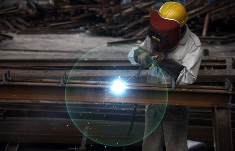 A worker welds at a machinery manufacturing factory in Huaibei, Anhui province August 20, 2013. REUTERS/Stringer A worker welds at a machinery manufacturing factory in Huaibei, Anhui province August 20, 2013. REUTERS/Stringer