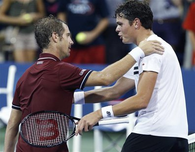 Milos Raonic of Canada (R) congratulates Richard Gasquet of France after Gasquet's win at the U.S. Open tennis championships in New York, Se Milos Raonic of Canada (R) congratulates Richard Gasquet of France after Gasquet's win at the U.S. Open tennis championships in New York, Se