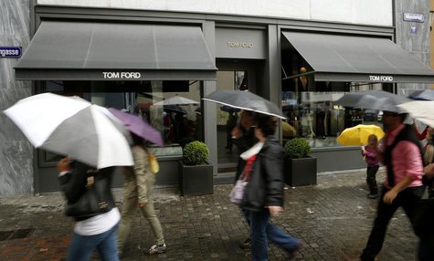 People walk past a store of U.S. fashion designer Tom Ford, operated in Switzerland by luxury goods chain Trois Pommes, in Zurich August 9, People walk past a store of U.S. fashion designer Tom Ford, operated in Switzerland by luxury goods chain Trois Pommes, in Zurich August 9,