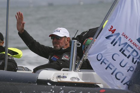 Oracle Corporation co-founder and CEO Larry Ellison waves to a passing boat prior to the first race of the Louis Vuitton Cup challenger seri Oracle Corporation co-founder and CEO Larry Ellison waves to a passing boat prior to the first race of the Louis Vuitton Cup challenger seri