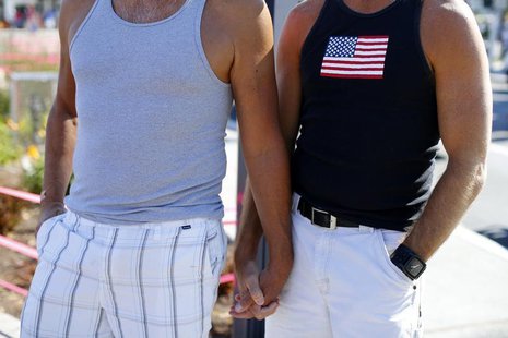 A gay couple holds hands during a rally in support of the United States Supreme Court decision on marriage rights in San Diego, California J A gay couple holds hands during a rally in support of the United States Supreme Court decision on marriage rights in San Diego, California J
