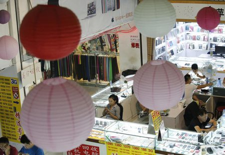 Sales people wait for customers at booths selling mobile phones in Beijing September 3, 2013. REUTERS/Kim Kyung-Hoon Sales people wait for customers at booths selling mobile phones in Beijing September 3, 2013. REUTERS/Kim Kyung-Hoon