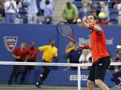 Security runs onto the court as Andy Murray of Britain hits a ball into the crowd to celebrate defeating Denis Istomin of Uzbekistan at the Security runs onto the court as Andy Murray of Britain hits a ball into the crowd to celebrate defeating Denis Istomin of Uzbekistan at the