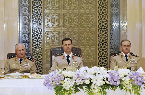 Syria's President Bashar al-Assad (C) attends a dinner in honor of the army officers on the 65th Army Foundation anniversary in Damascus Aug Syria's President Bashar al-Assad (C) attends a dinner in honor of the army officers on the 65th Army Foundation anniversary in Damascus Aug