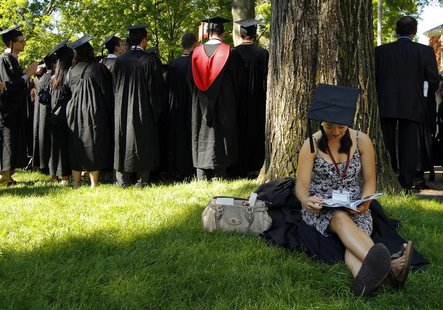 Graduating student Jennifer Lim sits in the shade before the start of the 361st Commencement Exercises at Harvard University in Cambridge, M Graduating student Jennifer Lim sits in the shade before the start of the 361st Commencement Exercises at Harvard University in Cambridge, M