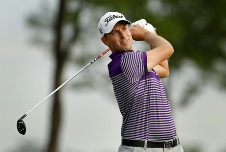 Webb Simpson of the U.S. watches his tee shot on the 13th hole during the weather delayed first round of the Barclays PGA golf tournament in Webb Simpson of the U.S. watches his tee shot on the 13th hole during the weather delayed first round of the Barclays PGA golf tournament in