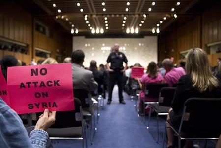 A protester holds up a sign against U.S. action in Syria as Chairman of the Joint Chiefs General Martin E. Dempsey, John Kerry, U.S. Secretary of State, and Chuck Hagel, Secretary of Defense, present the administration's case for U.S. military action against Syria to a Senate Foreign Relations Committee hearing in Washington September 3, 2013.
Credit: Reuters/Joshua Roberts A protester holds up a sign against U.S. action in Syria as Chairman of the Joint Chiefs General Martin E. Dempsey, John Kerry, U.S. Secretary of State, and Chuck Hagel, Secretary of Defense, present the administration's case for U.S. military action against Syria to a Senate Foreign Relations Committee hearing in Washington September 3, 2013.
Credit: Reuters/Joshua Roberts