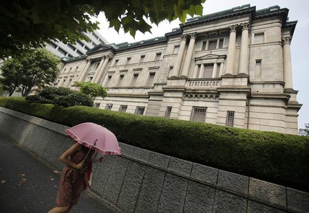 A pedestrian holding an umbrella walks past the Bank of Japan headquarters in Tokyo August 8, 2013. REUTERS/Yuya Shino A pedestrian holding an umbrella walks past the Bank of Japan headquarters in Tokyo August 8, 2013. REUTERS/Yuya Shino