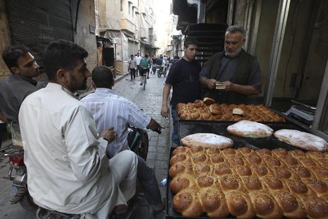 A street vendor sells traditional bread before the time for iftar, or breaking fast, during the Muslim fasting month of Ramadan in Aleppo, J A street vendor sells traditional bread before the time for iftar, or breaking fast, during the Muslim fasting month of Ramadan in Aleppo, J