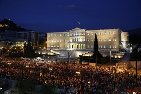 Demonstrators stand during a protest in front of the parliament in Athens July 17, 2013. REUTERS/Yannis Behrakis Demonstrators stand during a protest in front of the parliament in Athens July 17, 2013. REUTERS/Yannis Behrakis
